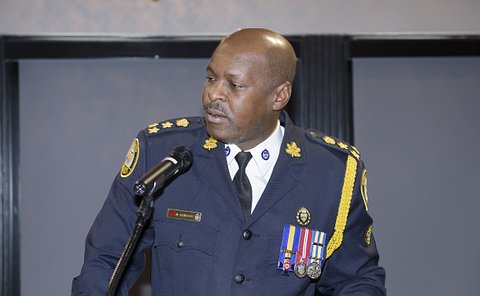 A man in TPS uniform at a podium
