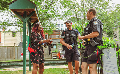 Two police officers talk to a woman