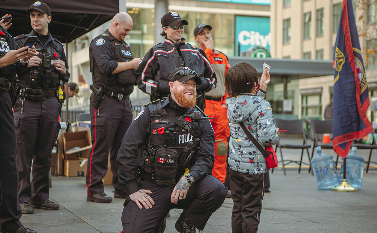 Police officer kneeling beside a child