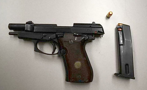 a handgun, bullet  and clip on a table