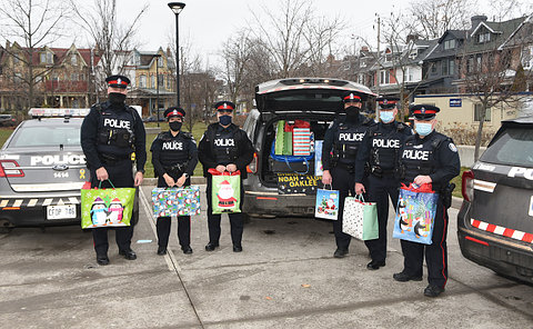 A group of officers holding gift bags