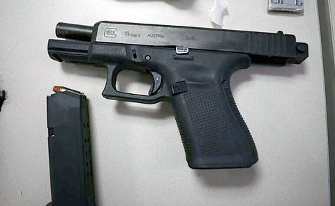 Photo of a handgun and a magazine of ammunition