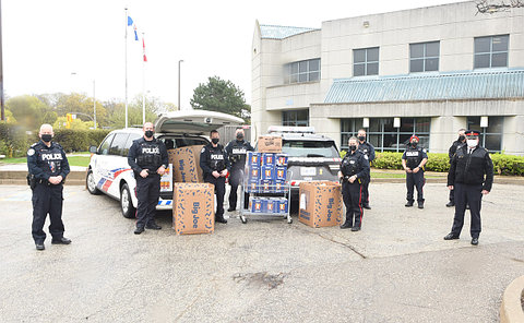 A group of TPS officers near containers of food