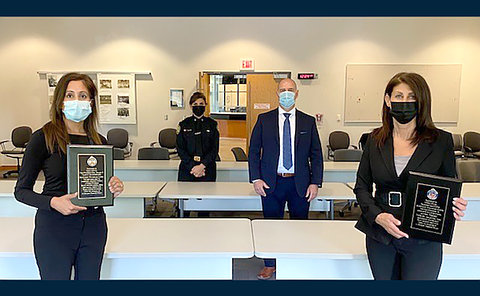 Four people standing apart with masks